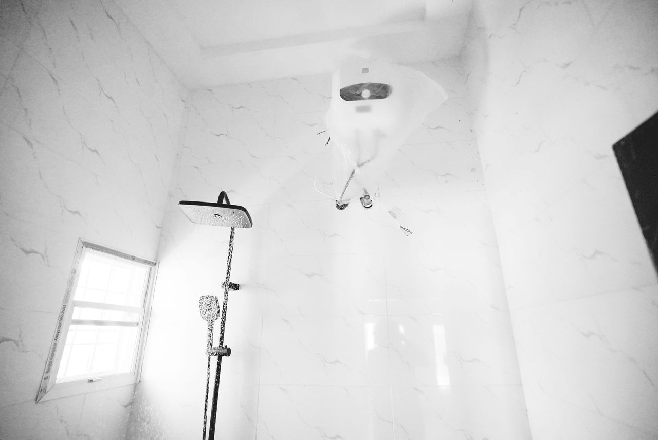 Modern rain shower with marble tiles